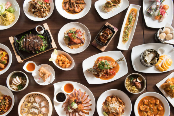 Overhead table shot of a beautiful assortment of Morimoto Asia plates of food